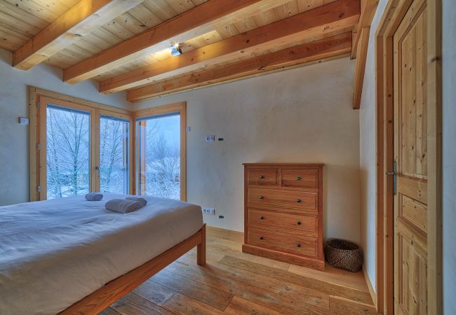 Spacious double bedroom with large windows